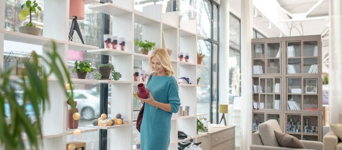 Good looking woman with a decorative vase in her hands.